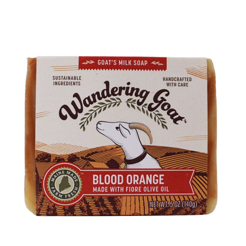 A bar of wrapped Wandering Goat Blood Orange Soap. The wrapper has the logo, goat head and banner that reads, "Blood Orange."